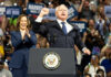 Kamala Harris and unidentified man at podium, cheering crowd.