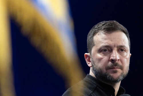 Person with short hair next to blurred yellow flag