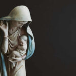 Religious statue of Madonna and child in prayer