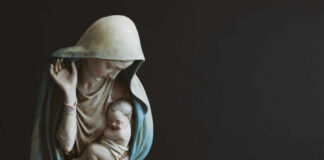 Religious statue of Madonna and child in prayer