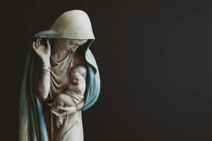 Religious statue of Madonna and child in prayer