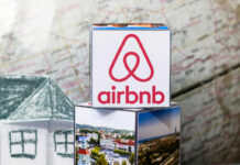 Airbnb logo on stack of cubes with map background