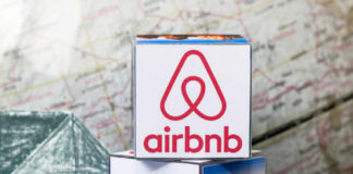 Airbnb logo on stack of cubes with map background