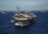 Aircraft carrier leads a naval fleet at sea