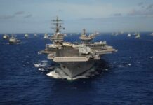 Aircraft carrier leads a naval fleet at sea