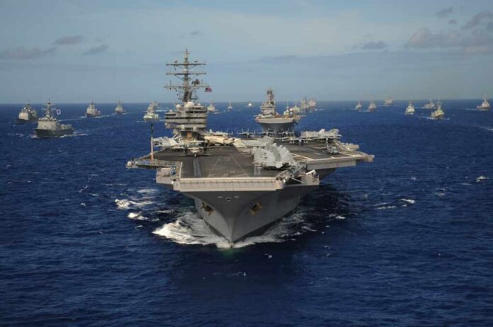 The,Nimitz-class,Aircraft,Carrier,Uss,Ronald,Reagan,Leads,A,Mass Aircraft carrier leads a naval fleet at sea