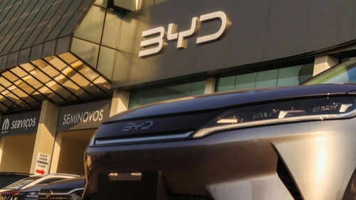 byd2512650637 Car dealership with BYD logo and vehicles displayed