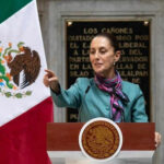 Cross-Border World Cup Drama: Iran’s Mexican Base Person speaking at podium with Mexican flag nearby