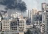 City buildings with heavy smoke and extensive war damage