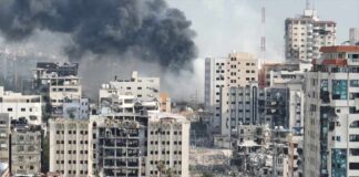 City buildings with heavy smoke and extensive war damage