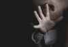 Kennedy’s Controversial Push to Reduce Child SSRI Use Child covering face with hand in dim light