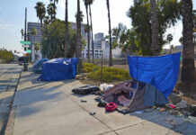 Taxpayer Outrage: Bass’s Homelessness Pledge Flops Tents and tarps line sidewalk near palm trees