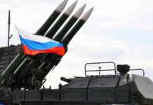 Military launcher with four missiles and Russian flag