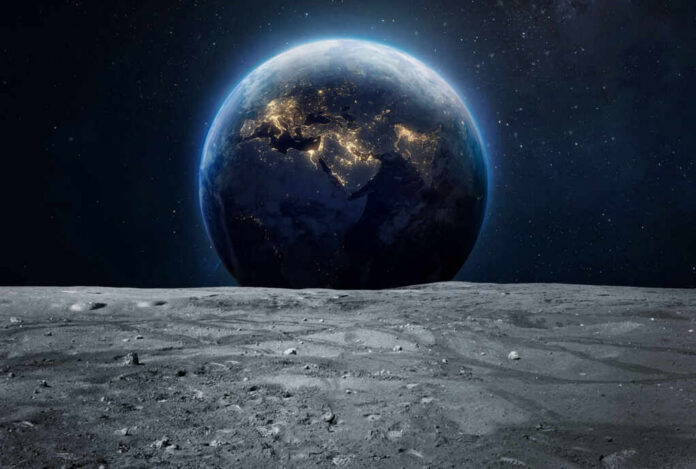 Earth rising above the moon’s barren surface in deep space