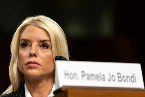 Woman sitting behind nameplate at conference or meeting