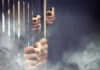 Trump Brokered MASSIVE Prisoner Swap — Could This Be It? Hands gripping prison bars in smoky atmosphere