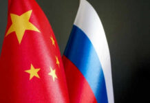Chinese and Russian flags on dark background