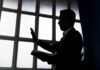 UK Pastor’s Trial: A Dangerous Precedent for Evangelism Silhouette of a person holding a book and raising a hand