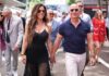 Bezos Ball Backlash: Met Gala’s Corporate Takeover A couple walking hand in hand at a public event, surrounded by people