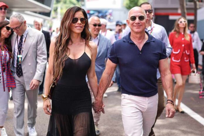 A couple walking hand in hand at a public event, surrounded by people