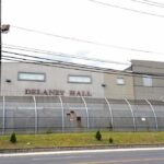 Newark Nights Explode — Officers Mauled, Chaos Spreads Detention facility behind barbed-wire fence along a street