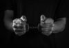 Fugitive Strangler Exploits Europe’s Justice Loophole Hands holding handcuffs in a black and white image