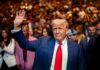 Health Bombshell: Trump Nails Cognitive Exam A man in a suit waving to a crowd at a public event