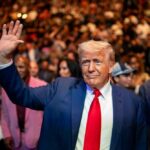 Health Bombshell: Trump Nails Cognitive Exam A man in a suit waving to a crowd at a public event