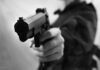 Shock Shooting: Deputy Shot in Hospital ER! Close-up of a person holding a handgun in a threatening manner
