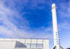 SpaceX Falcon 9 booster displayed outside industrial building