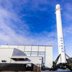 SpaceX Falcon 9 booster displayed outside industrial building