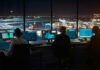 Runway Near Misses Force AI Takeover Air traffic controllers working at night airport tower