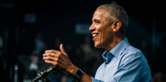 Smiling man speaking at a podium