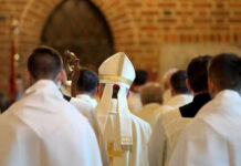 Lay Homilies? Rome Says Absolutely Not Clerics in white robes facing altar in church