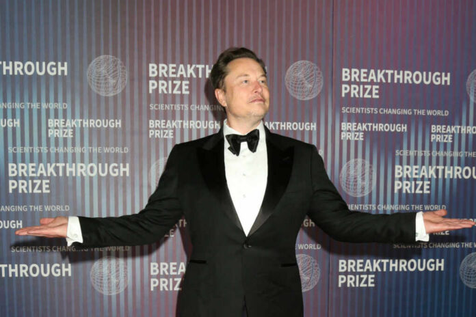 elon-musk-suit2449367659jpg man in a tuxedo posing with arms outstretched at an awards event