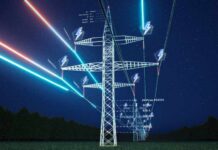 Texas Grid Warning Sparks Spain-Style Blackout Fears High-voltage transmission tower at night with glowing data overlays
