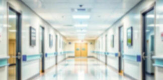 Blurred hospital corridor with doors and lights