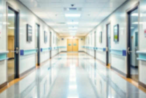 Blurred hospital corridor with doors and lights