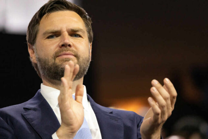 Man in suit clapping at an event