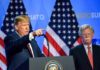 Bolton’s Guilty Plea Stuns D.C. Two men at a press conference with U.S. flags behind them