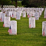 House Revolt Over Marine’s Denied Valor Rows of white headstones with American flags in a military cemetery