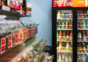 View of a supermarket aisle with a shopping cart in the foreground