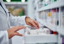 NHS Drug Chaos — Deadly Delays Spread Pharmacist organizing medication on a shelf