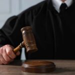 Store Owner Walks After Back-Shot Killing A judge holding a gavel above a wooden block