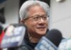 Nvidia Boss Pressures Trump — Hawks Furious Man speaking into a microphone on stage.