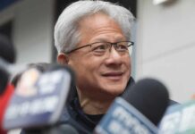 Nvidia Boss Pressures Trump — Hawks Furious Man speaking into a microphone on stage.