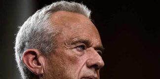 Close-up portrait of a serious-looking man with gray hair