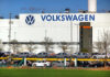Made-In-Europe Rule Sparks Trade War Fears Volkswagen factory exterior with new cars on transport racks