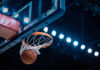 Congress Turns Heat On WNBA Basketball swishing through hoop under arena lights