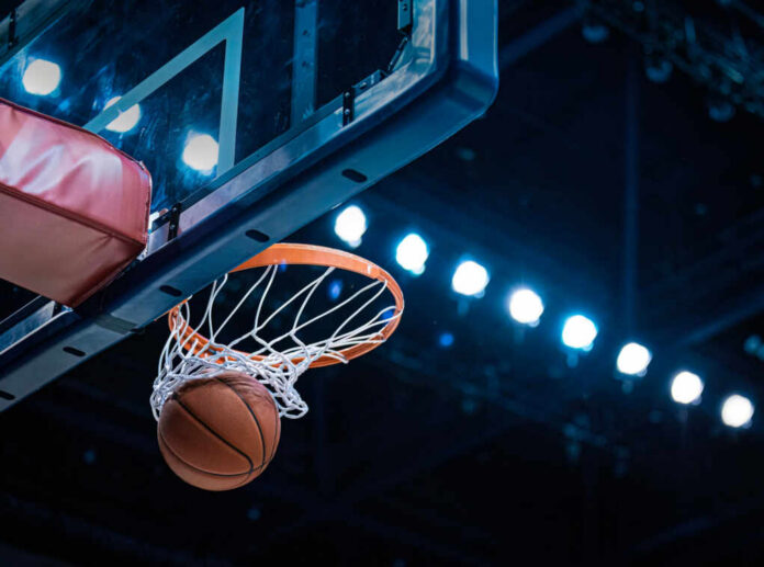 basketball-scoring-a-basket2441101363jpg Basketball swishing through hoop under arena lights
